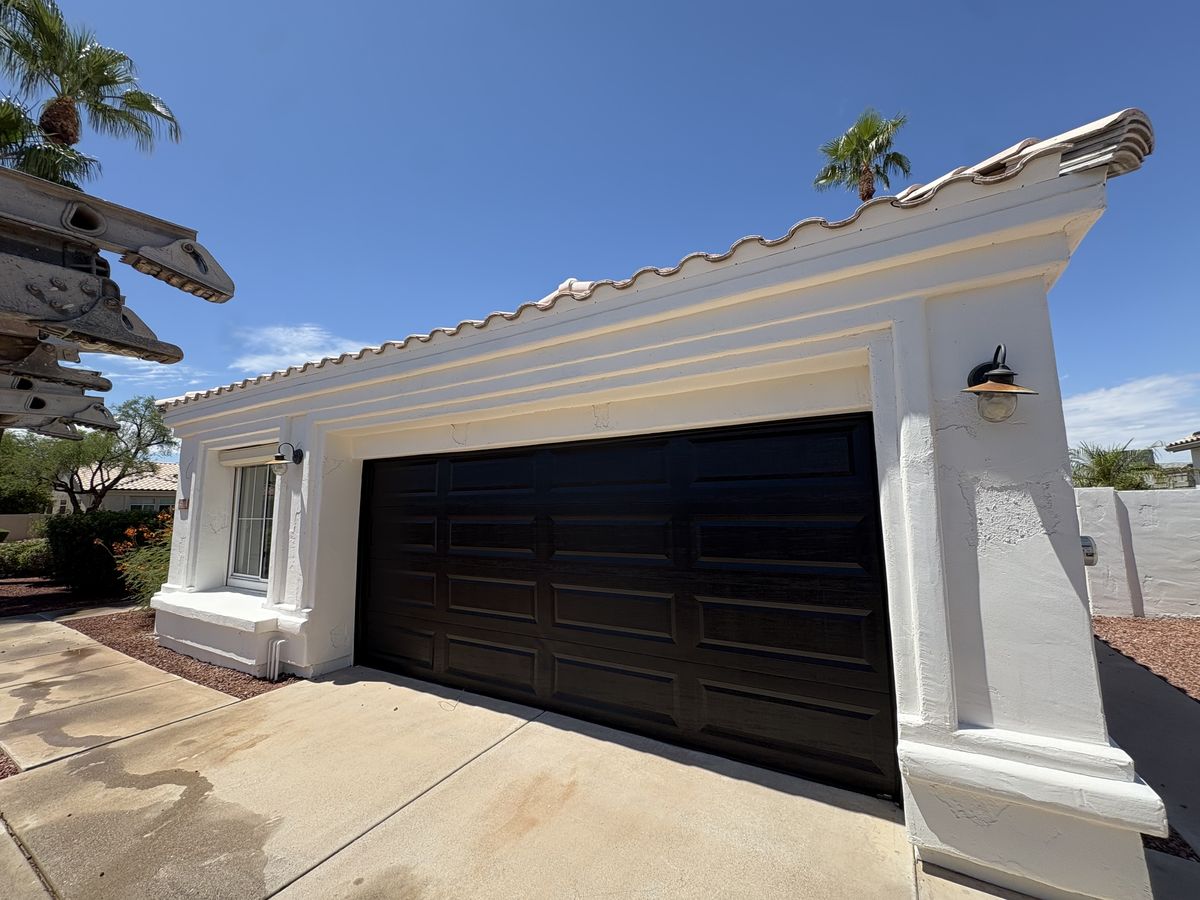 Exterior painting — white stucco with a dark-stained garage door — Royal Canyon Painting, Maricopa County AZ